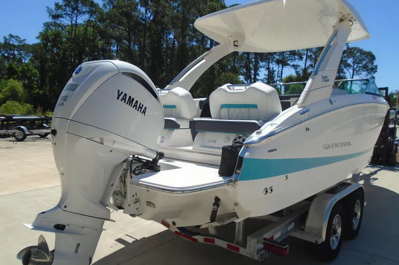 Slide: The Image of 2022 Regal LX6 boat with Yamaha outboard engine on trailer, parked outdoors. - 4