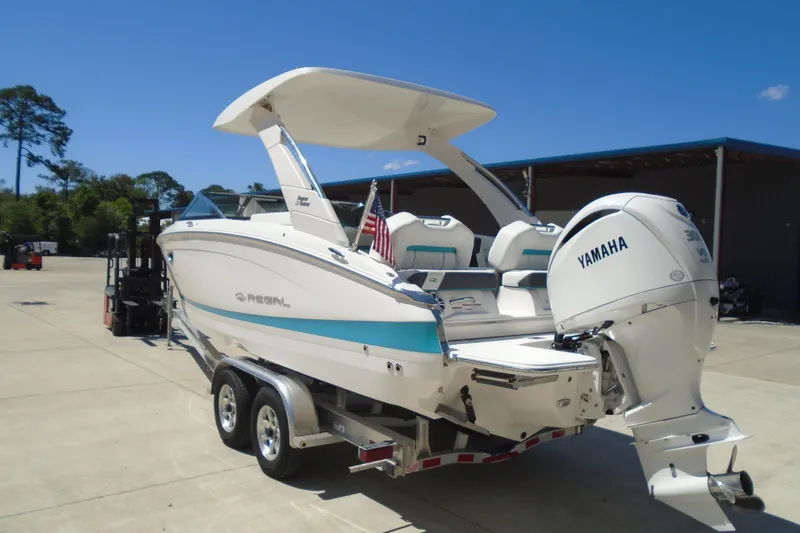 Slide: The Image of 2022 Regal LX6 boat with Yamaha engine on trailer, parked outdoors. - 5