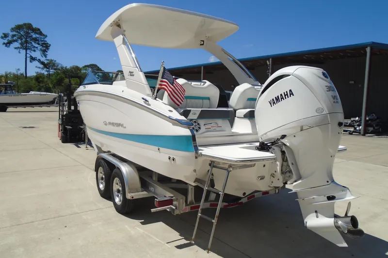 Slide: The Image of 2022 Regal LX6 boat with Yamaha engine on trailer, parked outdoors. - 7