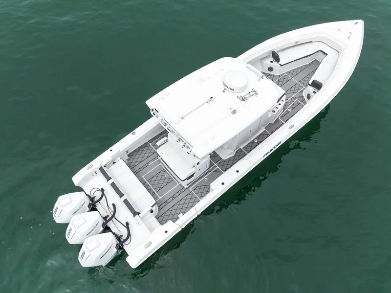 Slide: The Image of 2023 Fountain 38 CC boat with triple outboard engines on water. - 1