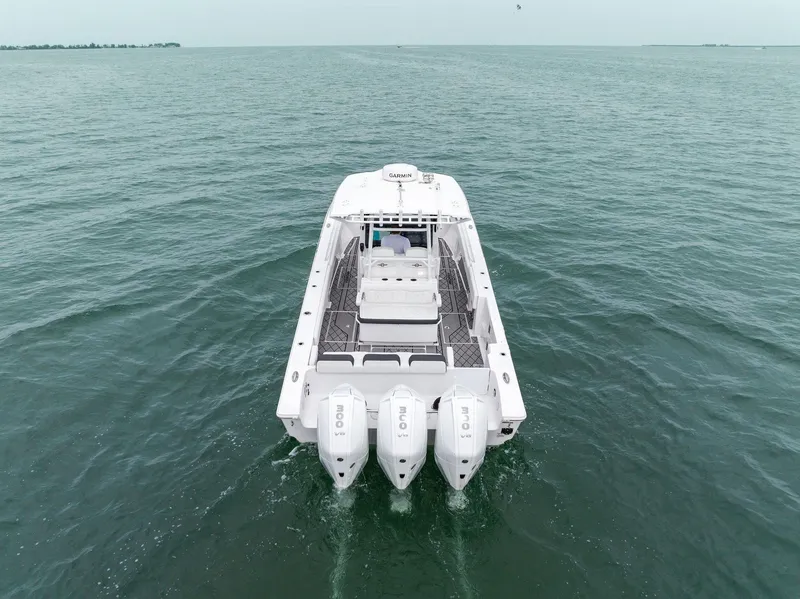 Slide: The Image of 2023 Fountain 38 CC boat cruising on open water. - 11