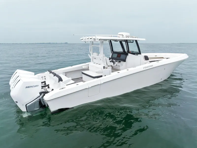 Slide: The Image of 2023 Fountain 38 CC boat on calm water, featuring Mercury outboard engines. - 14
