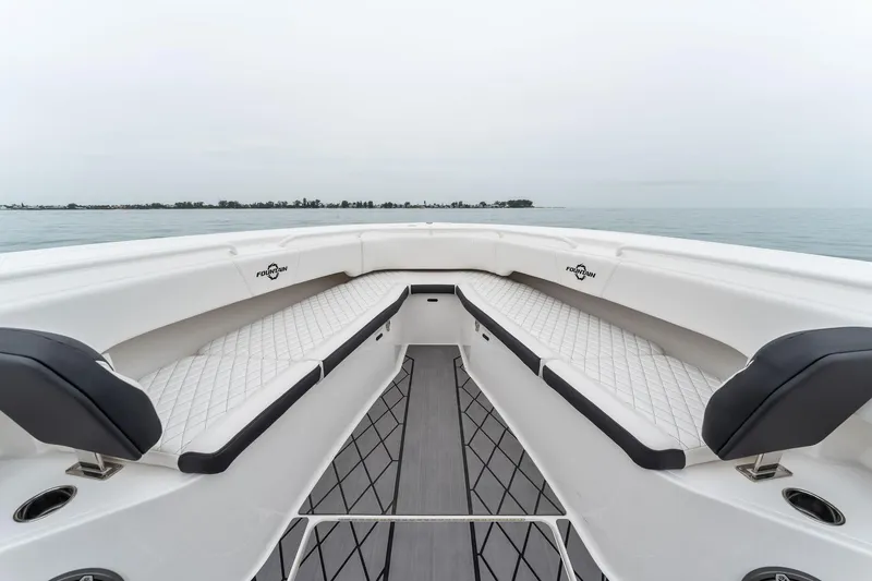 Slide: The Image of 2023 Fountain 38 CC boat interior with cushioned seating. - 18
