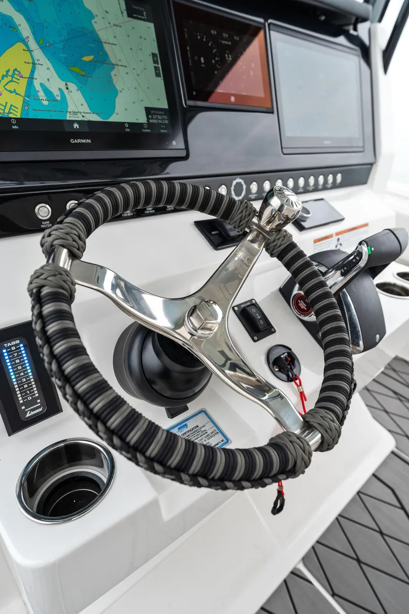 Slide: The Image of Steering wheel and dashboard of 2023 Fountain 38 CC boat with navigation screens. - 20