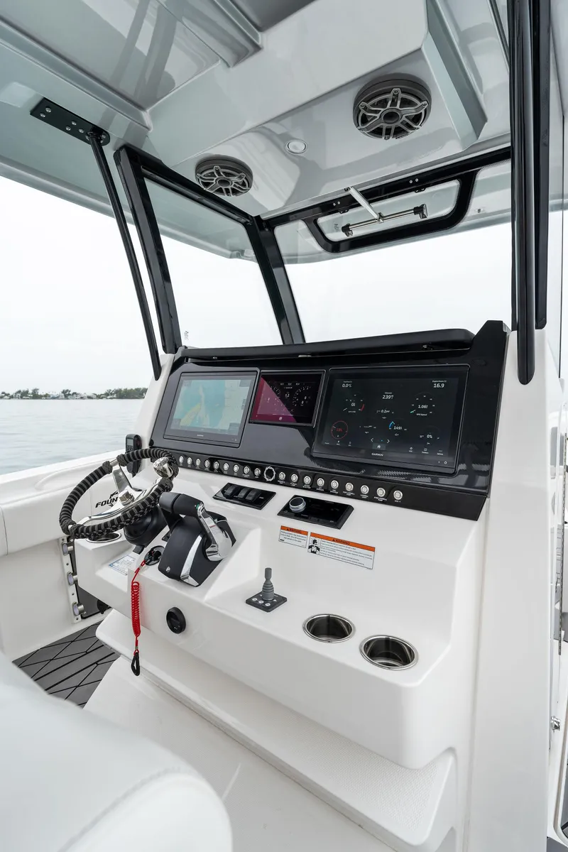 Slide: The Image of 2023 Fountain 38 CC boat dashboard with modern navigation and control systems. - 22