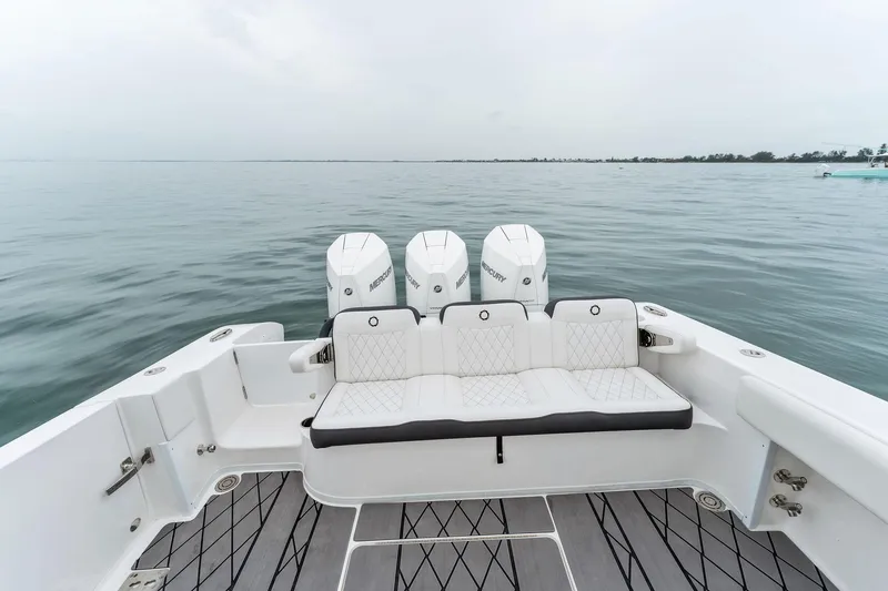 Slide: The Image of 2023 Fountain 38 CC boat with triple outboard engines on calm water. - 28