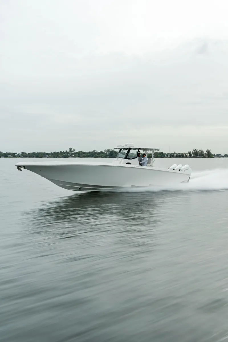 Slide: The Image of 2023 Fountain 38 CC boat cruising on calm water. - 3