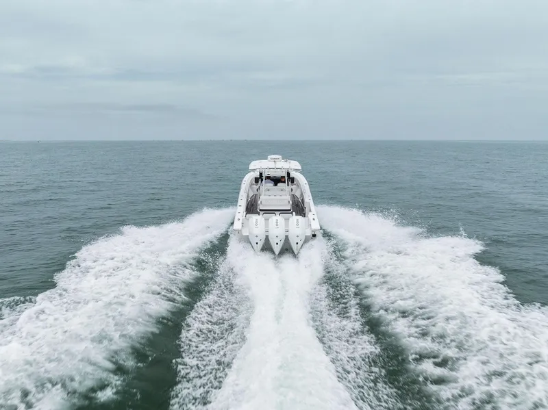 Slide: The Image of 2023 Fountain 38 CC boat speeding on open water. - 34