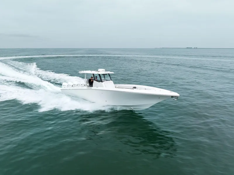Slide: The Image of 2023 Fountain 38 CC boat cruising on open water. - 35
