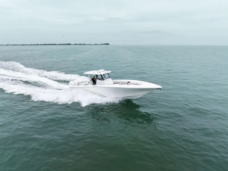 Slide: The Image of 2023 Fountain 38 CC boat cruising on open water. - 36