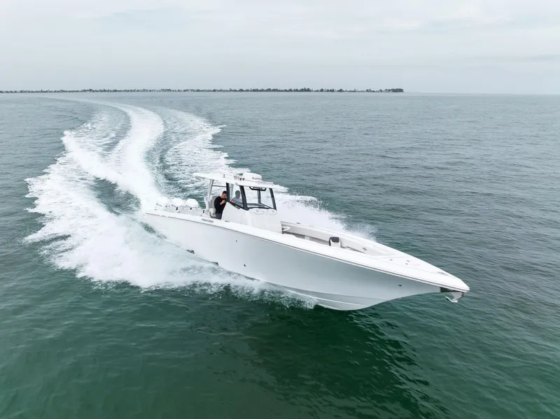 Slide: The Image of 2023 Fountain 38 CC boat cruising on open water. - 5