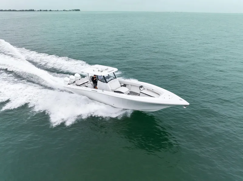 Slide: The Image of 2023 Fountain 38 CC boat cruising on open water. - 6
