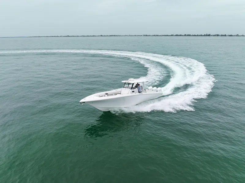 Slide: The Image of 2023 Fountain 38 CC boat cruising on open water. - 8