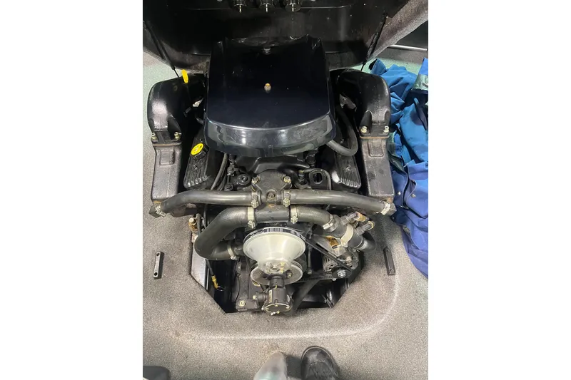 Slide: The Image of 2005 Malibu 21 Ride boat engine, detailed view with surrounding components. - 3