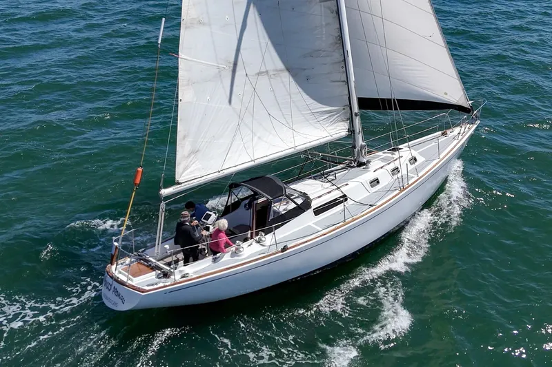 Slide: The Image of 1970 Morgan 42 MKI sailboat navigating ocean waters with crew onboard. - 11