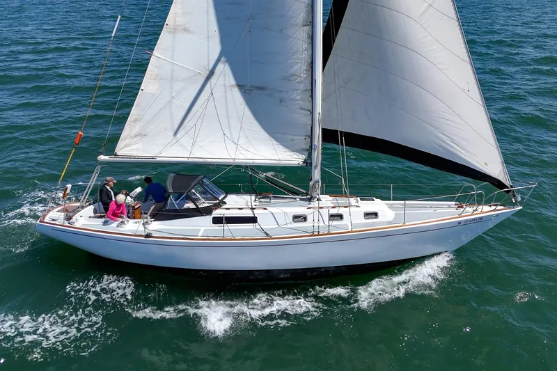 Slide: The Image of 1970 Morgan 42 MKI sailboat cruising on open water with passengers onboard. - 12