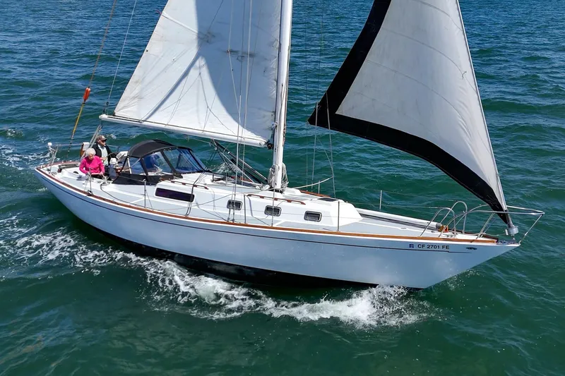 Slide: The Image of 1970 Morgan 42 MKI sailboat cruising on open water with passengers onboard. - 13