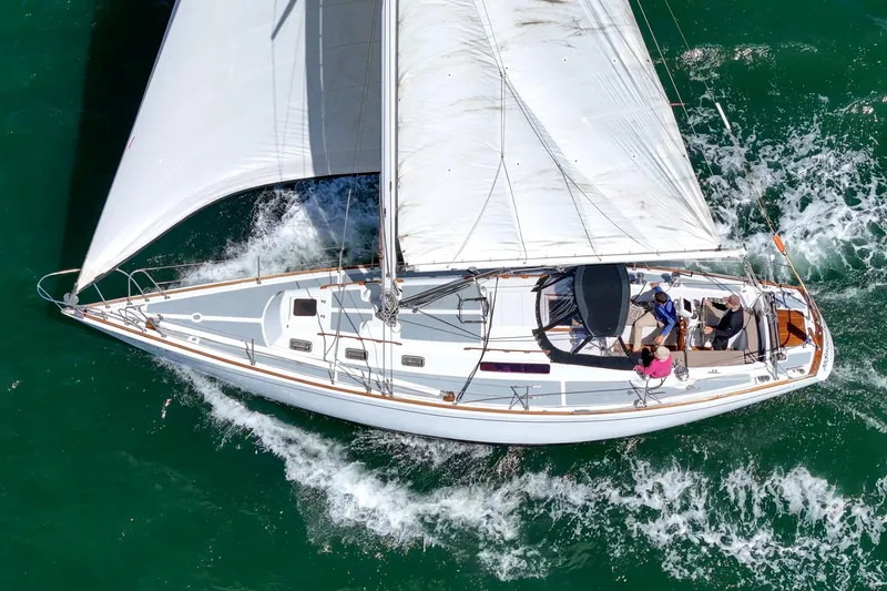 Slide: The Image of 1970 Morgan 42 MKI sailboat navigating through vibrant green waters. - 18