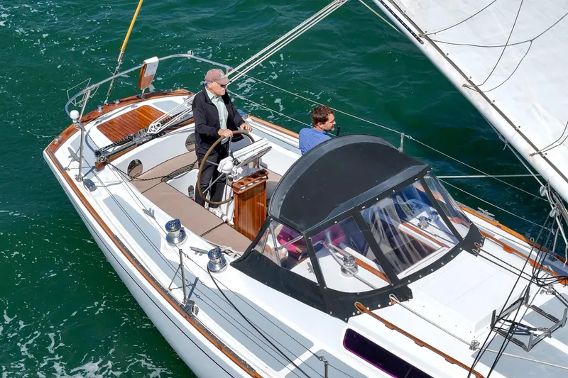 Slide: The Image of 1970 Morgan 42 MKI sailboat with two people navigating on open water. - 19