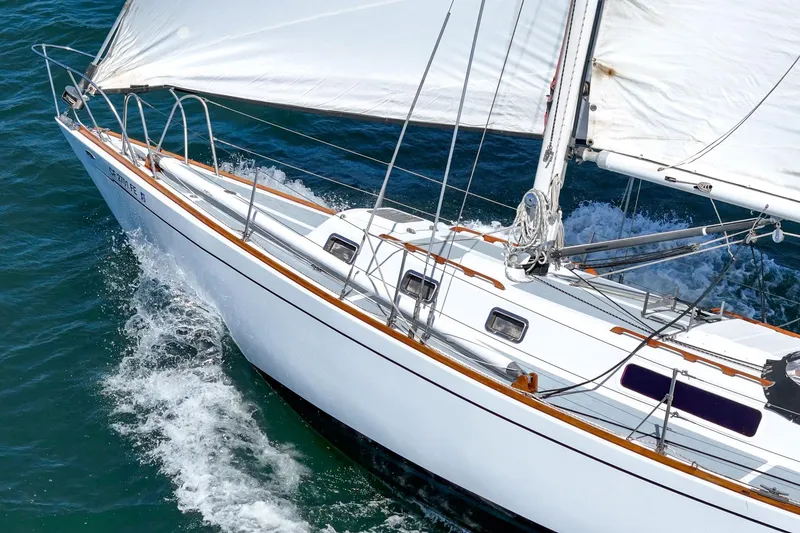 Slide: The Image of 1970 Morgan 42 MKI sailboat gliding through blue ocean waters. - 22