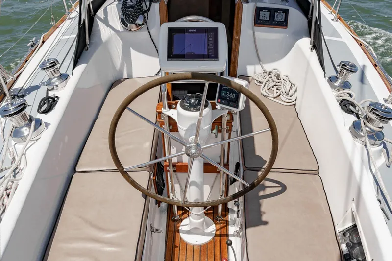Slide: The Image of Cockpit of a 1970 Morgan 42 MKI sailboat with steering wheel and navigation equipment. - 24