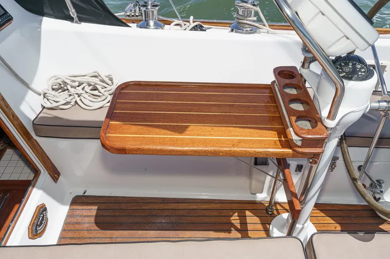 Slide: The Image of 1970 Morgan 42 MKI yacht cockpit with wooden table and rope, showcasing nautical design. - 30