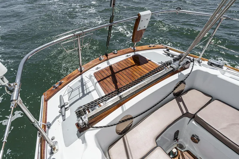 Slide: The Image of 1970 Morgan 42 MKI sailboat cockpit with wooden deck and cushioned seating on water. - 31