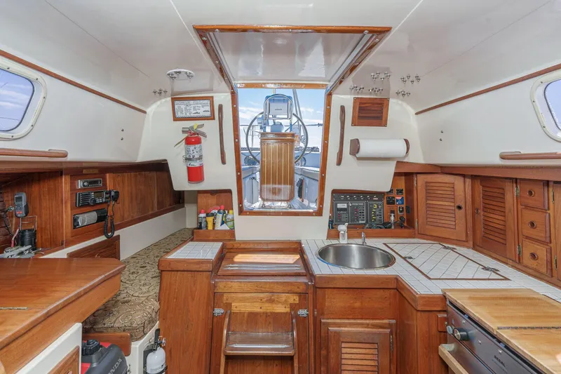 Slide: The Image of Interior of a 1970 Morgan 42 MKI sailboat with wooden cabinetry and nautical equipment. - 37