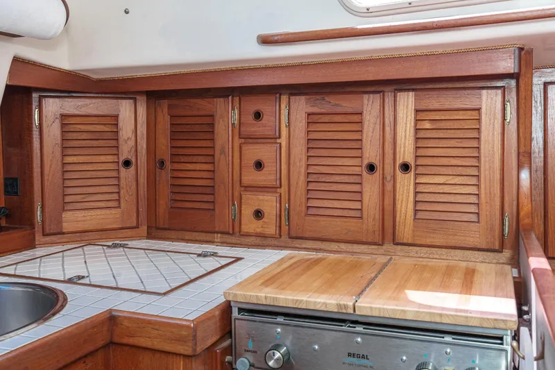 Slide: The Image of Wooden cabinetry and tiled countertop in a 1970 Morgan 42 MKI yacht kitchen. - 39