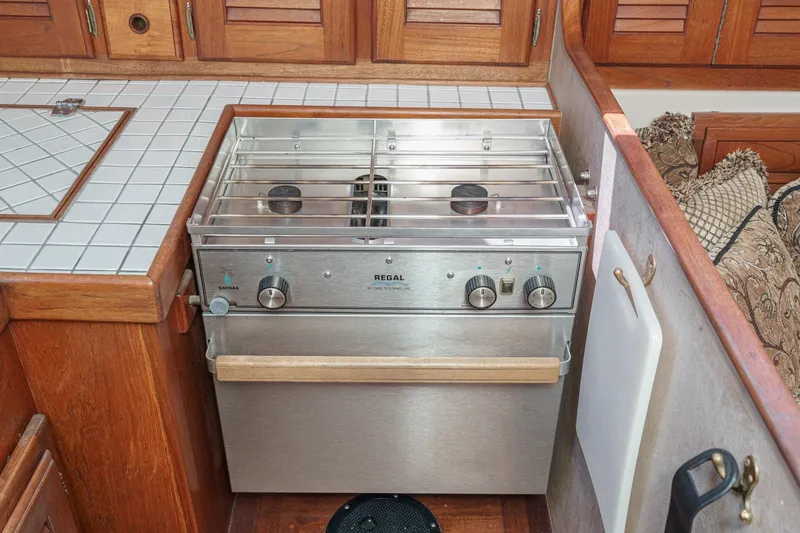 Slide: The Image of 1970 Morgan 42 MKI yacht kitchen with stainless steel stove and wooden cabinetry. - 40