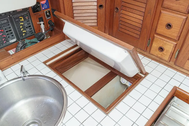 Slide: The Image of 1970 Morgan 42 MKI yacht interior with open storage compartment and control panel. - 42