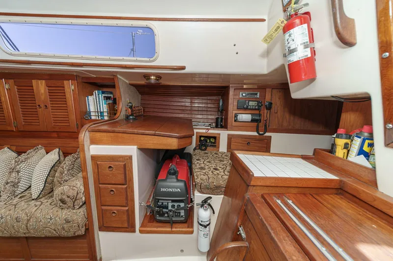 Slide: The Image of Interior of a 1970 Morgan 42 MKI sailboat with wooden cabinetry and Honda generator. - 44
