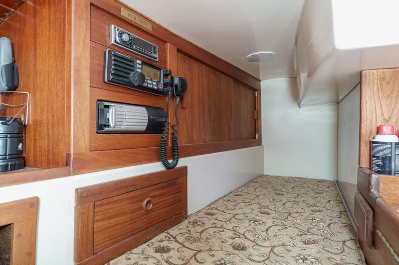 Slide: The Image of 1970 Morgan 42 MKI cabin interior with wood paneling and communication equipment. - 47