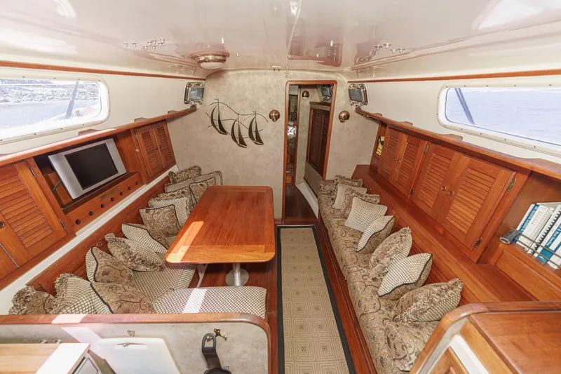 Slide: The Image of Interior of a 1970 Morgan 42 MKI yacht with wooden furnishings and cozy seating. - 49