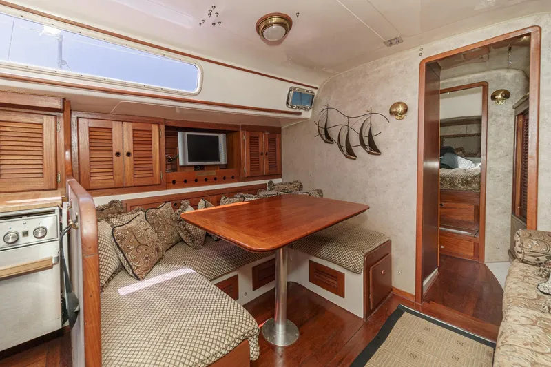 Slide: The Image of Interior of a 1970 Morgan 42 MKI sailboat with cozy dining area and wooden cabinetry. - 50
