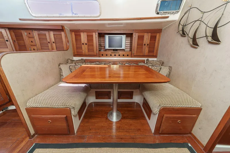Slide: The Image of Cozy dining area in a 1970 Morgan 42 MKI yacht with wooden table and cushioned seating. - 51