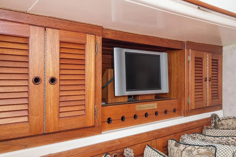 Slide: The Image of 1970 Morgan 42 MKI yacht interior with wooden cabinets and a mounted TV. - 52