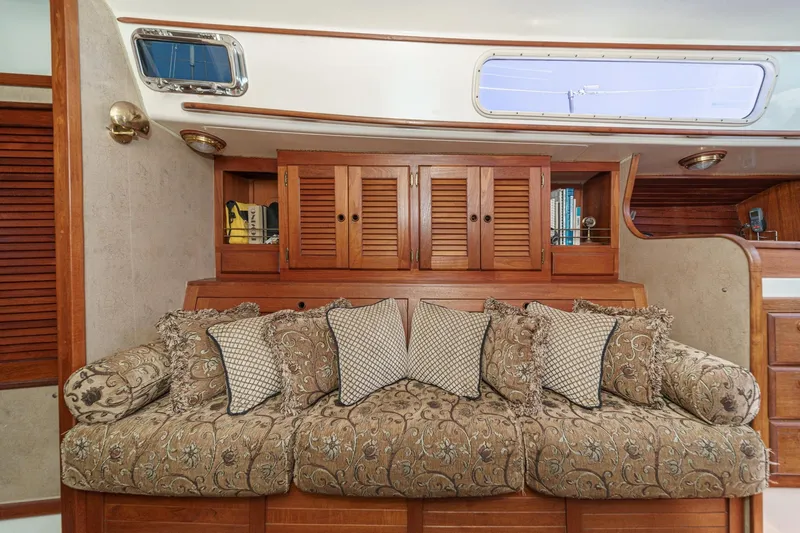 Slide: The Image of Luxurious interior of a 1970 Morgan 42 MKI yacht with ornate sofa and wooden cabinetry. - 57
