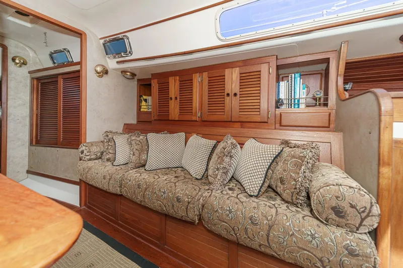 Slide: The Image of Interior of a 1970 Morgan 42 MKI yacht with elegant wood paneling and plush seating. - 58