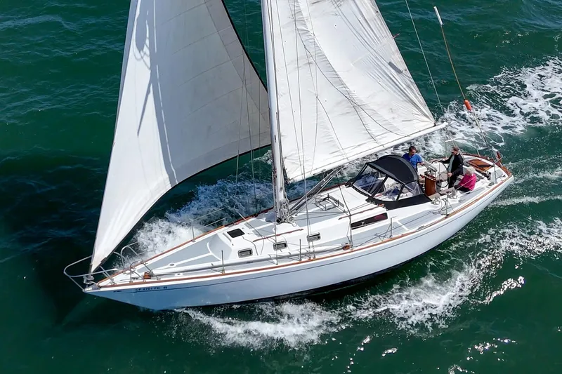 Slide: The Image of 1970 Morgan 42 MKI sailboat navigating ocean waters with full sails. - 6