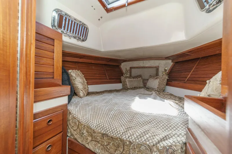 Slide: The Image of Cozy cabin interior of a 1970 Morgan 42 MKI sailboat with wooden accents and plush bedding. - 61