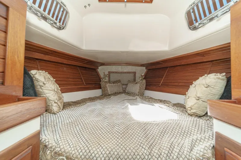 Slide: The Image of Cozy cabin interior of a 1970 Morgan 42 MKI sailboat with elegant bedding and wooden accents. - 62