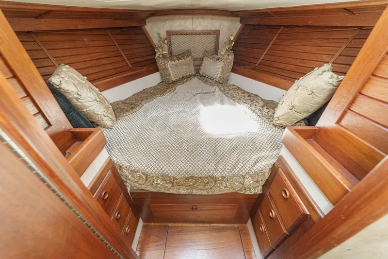 Slide: The Image of Cozy cabin interior of a 1970 Morgan 42 MKI sailboat with wooden finishes and plush bedding. - 63