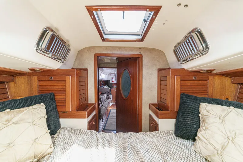 Slide: The Image of Interior cabin of a 1970 Morgan 42 MKI sailboat with wood accents and cozy bedding. - 64