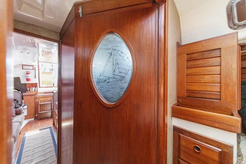 Slide: The Image of Interior of 1970 Morgan 42 MKI sailboat with wooden cabinetry and etched glass door. - 65