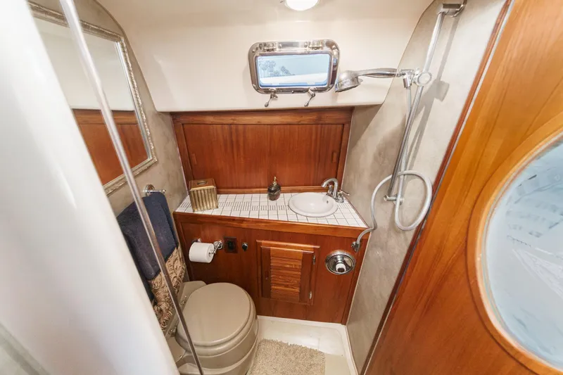 Slide: The Image of 1970 Morgan 42 MKI yacht bathroom with wooden cabinetry, sink, and shower. - 66
