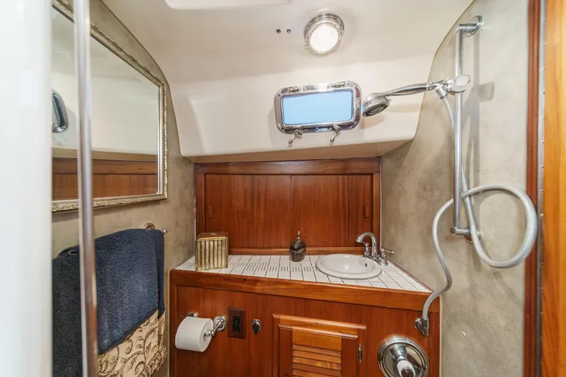 Slide: The Image of 1970 Morgan 42 MKI yacht bathroom with wooden cabinetry, sink, and shower. - 67