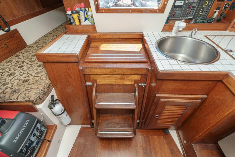 Slide: The Image of 1970 Morgan 42 MKI yacht interior with wooden cabinetry, sink, and storage. - 69