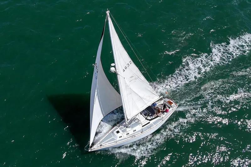 Slide: The Image of Aerial view of 1970 Morgan 42 MKI sailboat navigating through vibrant green waters. - 7