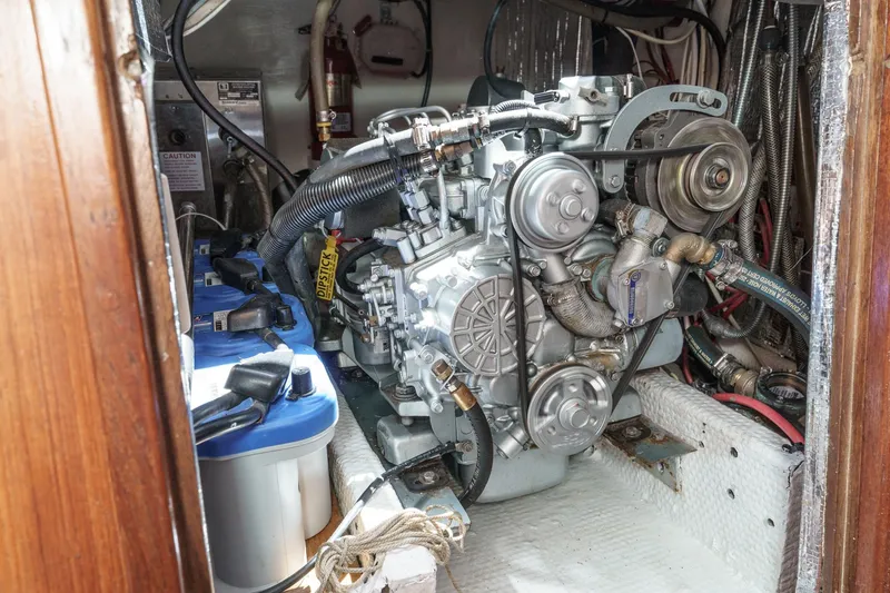 Slide: The Image of Engine compartment of a 1970 Morgan 42 MKI sailboat, showcasing mechanical components and wiring. - 73